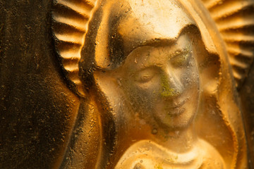 Close up gold ancient statue of the Virgin Mary.