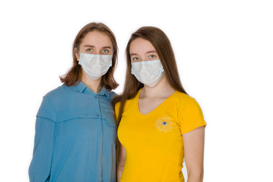 Two teenagers aged 14 and 17 with a protective virus mask on a white background