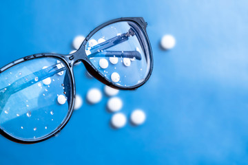 Glasses with white pills, eye care concept. Health care. Ophthalmology concept. Eyesight concept.