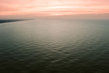 Small ocean waves at the sunset