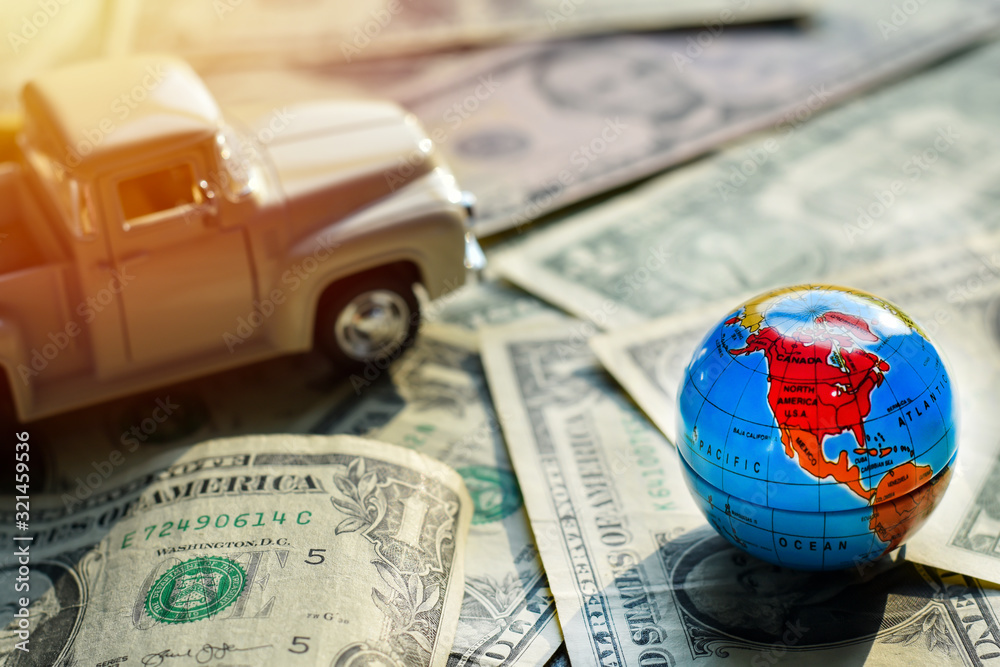 Wall mural world map on money dollars, concept investments for tourism has model car is backdrop.