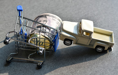 Concept business accident, Close-up view model shopping cart and toy car on table desk.