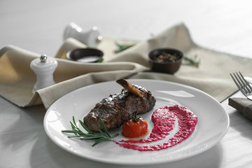 Delicious roasted rib served on white wooden table