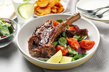 Delicious grilled ribs served on light grey table