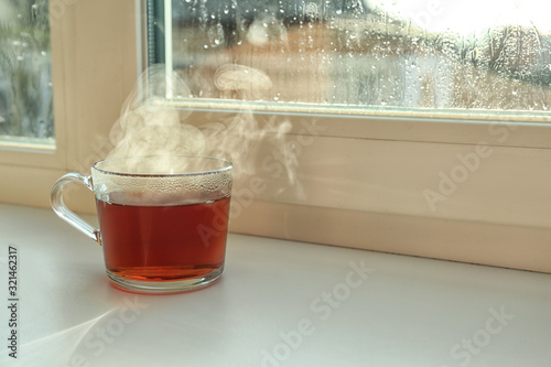 Cup Of Hot Tea Near Window On Rainy Day Space For Text Wall Mural Wallpaper Murals New Africa