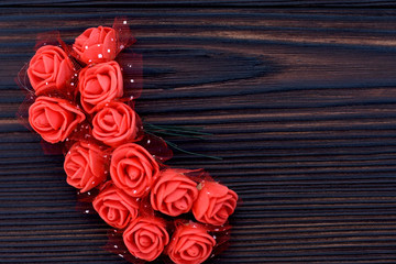 beautiful red roses lie on a dark chocolate background