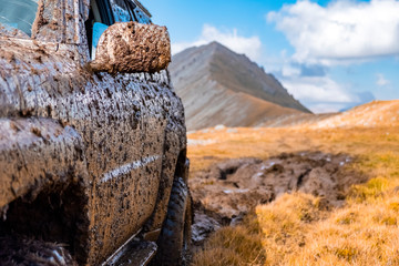 Adventure travel concept background. 4x4 off-road suv car stuck in mud. Adventure travel concept background. Offroad car. © Adil