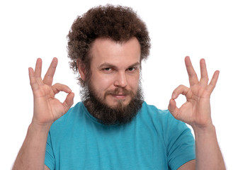 Portrait of bearded man with funny Curly Hair making Ok gesture, isolated on white background. Happy male smiling and showing okay sign. Caucasian man looking at camera.