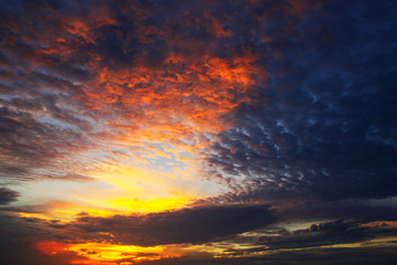 sunset with clouds,Beautiful, dramatic, fiery sunset, in orange, red,black, yellow, and blue colors.