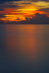 sunset seascape, expanse of the sea and fiery cloudy sky, travel concept
