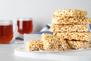 Delicious rice crispy treats on light grey table