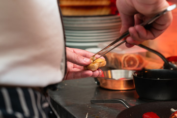 Chef picking fried garlic