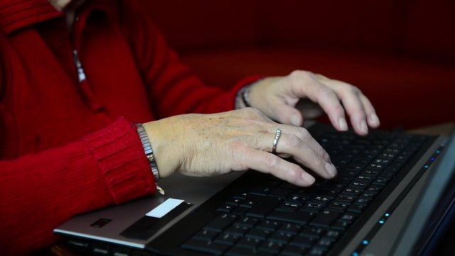 Closeup Of Elder Caucasian Female Hands Typing On Black Keyword