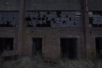 Fototapeta na wymiar Abandoned building smashed windows
