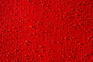 Droplets pattern on red backdrop. Juice splash. Red juicy surface drops, great design for any purposes. Texture background, pattern. Summer bright background. Bright sweet color.