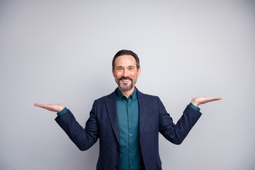 Photo of handsome sales manager worker man advising hold two products on open arms pick one better formalwear shirt blazer plaid blue suit isolated grey color background