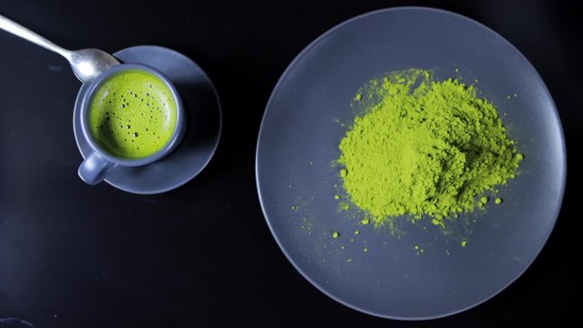 Close-up view of matcha tea on black background