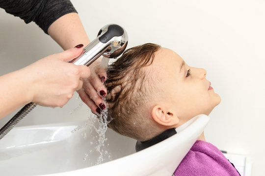Close up picture of boy/child kid, sitting in the hairdressing salon