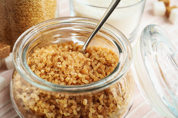 Glass bowl with brown sugar on table, closeup
