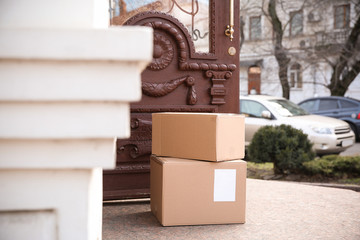 Delivered parcel boxes near open entrance door