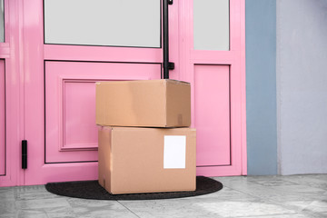 Delivered parcels on door mat near entrance