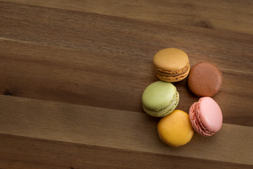 delicious multi flavor Macarons over wooden board with space for text