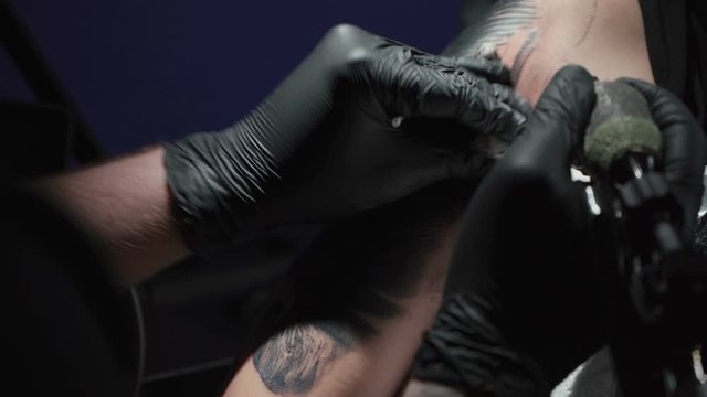 Video of man doing black tattoo on woman