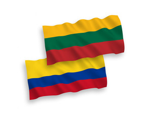 National vector fabric wave flags of Lithuania and Colombia isolated on white background. 1 to 2 proportion.