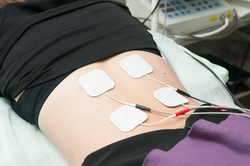 Ultrasound and electrotherapy treatment for a young woman