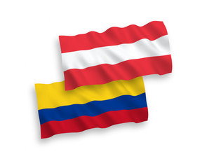 National vector fabric wave flags of Austria and Colombia isolated on white background. 1 to 2 proportion.