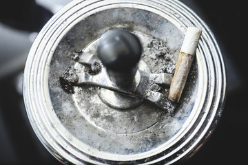 cigarette on an ashtray on a dark background