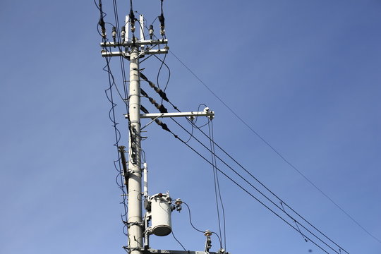 high electric power pole on background of blue sky