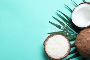 Flat lay composition with fresh coconut flakes on turquoise background. Space for text