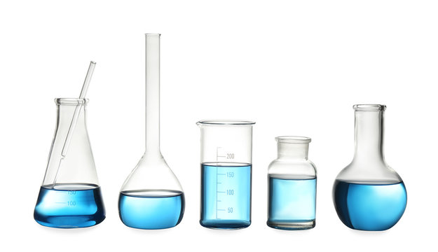 Different laboratory glassware with light blue liquid isolated on white