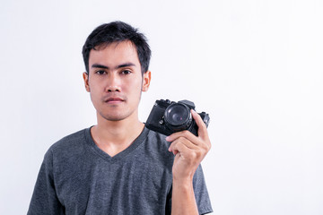 Man holding vintage camera on white