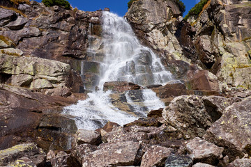 Beautiful waterfall flowing from top of a stone wall. The Skok waterfal near to Strbske Pleso in High Tatras National Park, Slovakia © andras_csontos