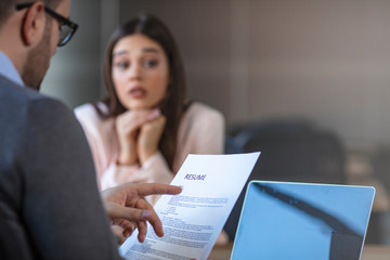 Nervous young job applicant wait for recruiters question during interview in office, worried intern...