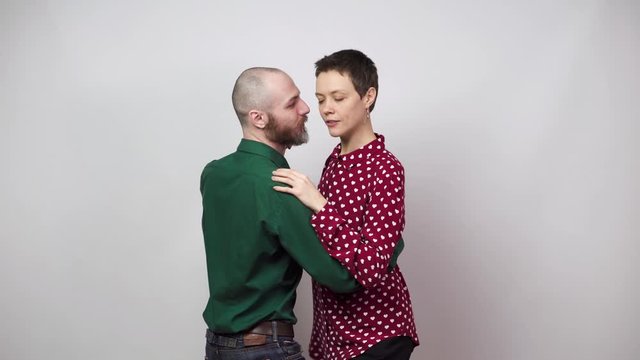Romantic couple dancing on white background. Man and woman are dancing slow blues dance. Sensual couple dancing.