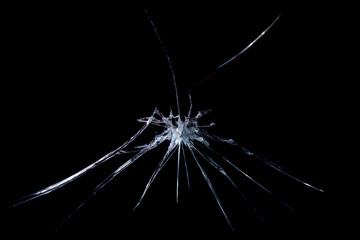 crack in the form of abstraction on broken glass mirror on a black background