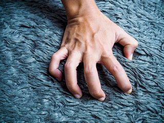 Asian people with acute illness and spasms jerk in hand or finger pain.