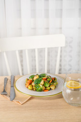 Delicious roasted Brussels sprouts served on wooden table