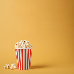 Delicious popcorn on yellow background. Space for text