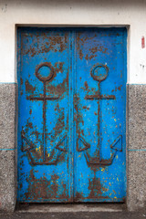 Blue old door with anchors decoration