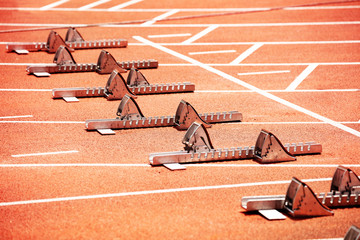 Fototapeta premium Close-up of starting blocks on stadium track for sprint running