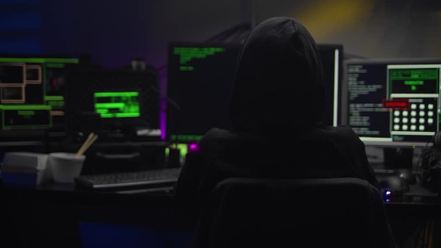 female hacker in dark room creating code