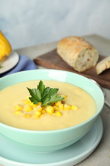Delicious corn cream soup served on light grey table