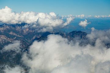 Aerial view from above at amazing scenic cloudy mountainside landscape as seen from 2000 metres highness.