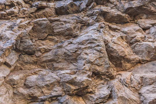 Closeup view of real structure of stone background. Mountain in cut.