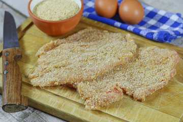 escalope de volaille panées sur une planche à découper