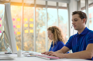 Obraz premium Male caller or receptionist phone operator. Call Center Service. Photo of customer support or sales agent. Help line answering and telemarketing.